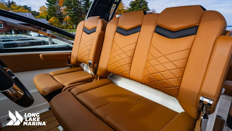 Slide: The Image of 2024 Chaparral 300 OSX boat seats with tan leather and diamond stitching at Long Lake Marina. - 18