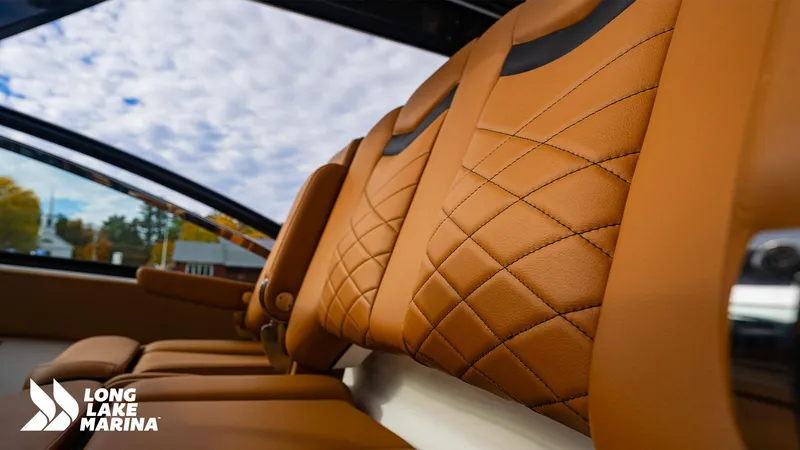 Slide: The Image of Luxurious tan leather seats in 2024 Chaparral 300 OSX boat at Long Lake Marina. - 19