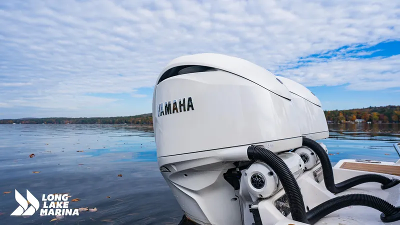 Slide: The Image of 2024 Chaparral 300 OSX with Yamaha engines on a serene lake, Long Lake Marina logo visible. - 21