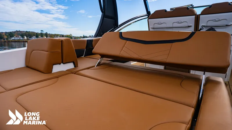 Slide: The Image of 2024 Chaparral 300 OSX boat interior with tan leather seating at Long Lake Marina. - 22