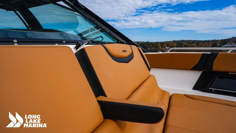 Slide: The Image of 2024 Chaparral 300 OSX boat interior with tan and black seating at Long Lake Marina. - 23