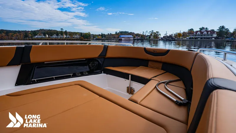 Slide: The Image of 2024 Chaparral 300 OSX boat interior with tan seating, docked at Long Lake Marina. - 25