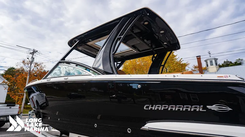 Slide: The Image of 2024 Chaparral 300 OSX boat at Long Lake Marina, showcasing sleek black design. - 28