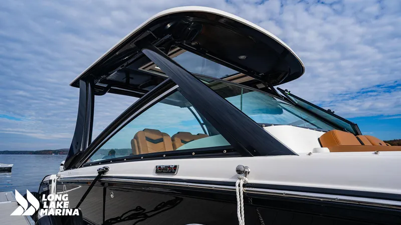 Slide: The Image of 2024 Chaparral 300 OSX boat at Long Lake Marina, featuring sleek design and modern amenities. - 6