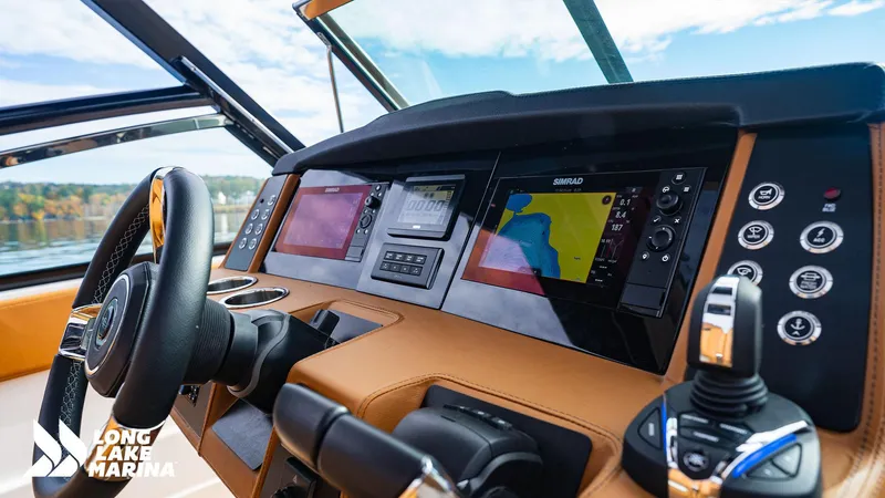 Slide: The Image of 2024 Chaparral 300 OSX boat dashboard with navigation screens and controls. - 7