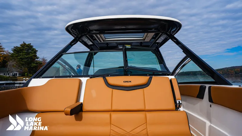 Slide: The Image of 2024 Chaparral 300 OSX boat interior with tan seating at Long Lake Marina. - 9