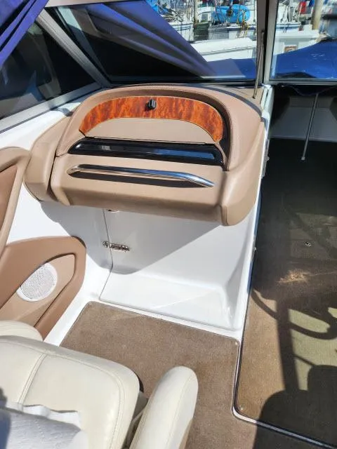 Slide: The Image of 2008 Cobalt 252 boat interior with beige and wood accents. - 16