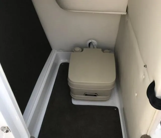 Slide: The Image of 2008 Cobalt 252 boat interior with portable toilet. - 18