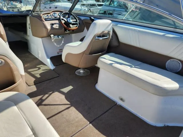 Slide: The Image of 2008 Cobalt 252 boat interior with beige and white seating, steering wheel, and dashboard. - 19
