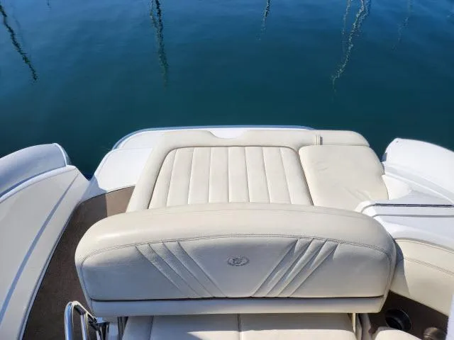 Slide: The Image of 2008 Cobalt 252 boat with white leather seating on calm water. - 21