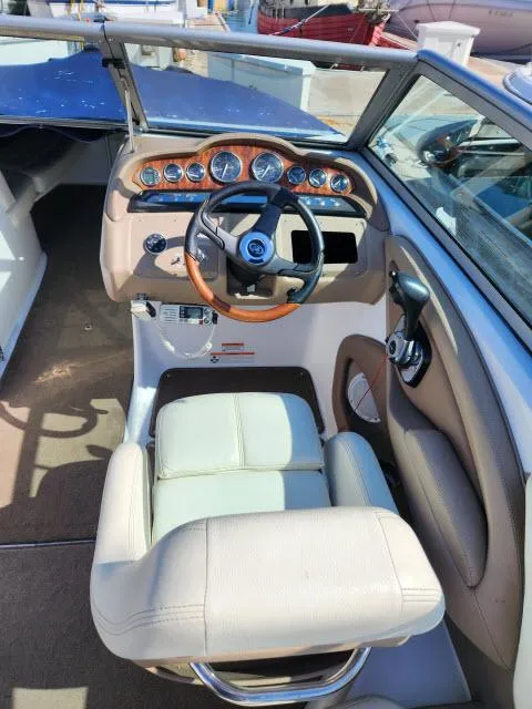 Slide: The Image of 2008 Cobalt 252 boat cockpit with steering wheel and control panel. - 22