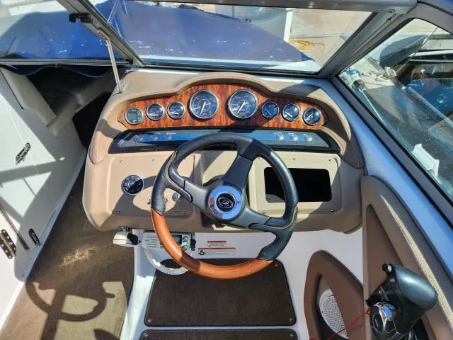 Slide: The Image of 2008 Cobalt 252 boat dashboard with steering wheel and instrument panel. - 23