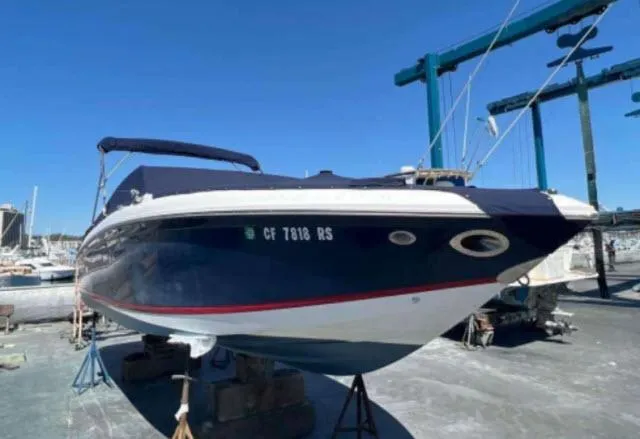Slide: The Image of 2008 Cobalt 252 boat on dry dock with blue cover. - 31