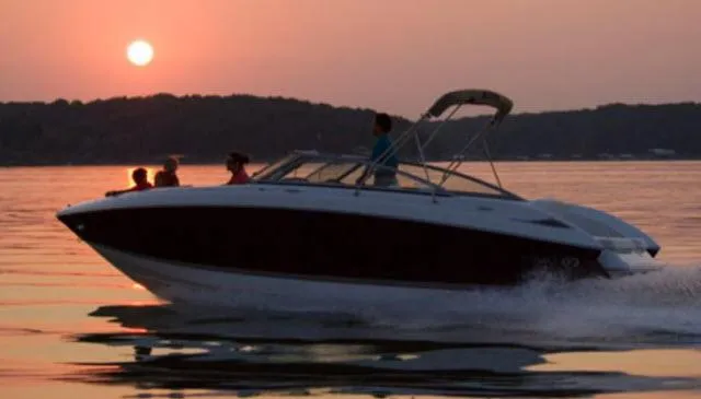 Slide: The Image of 2008 Cobalt 252 boat cruising at sunset on a calm lake. - 34