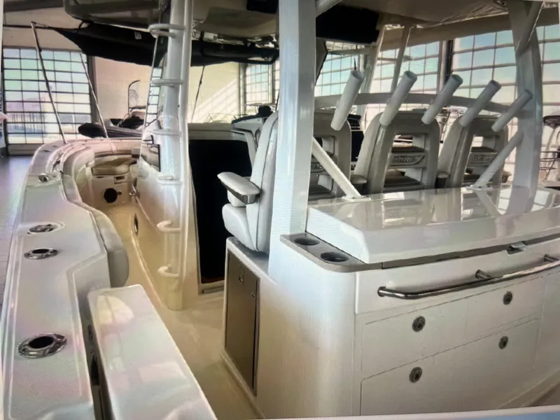 Slide: The Image of 2020 Boston Whaler 380 Outrage interior with seating and storage compartments. - 18