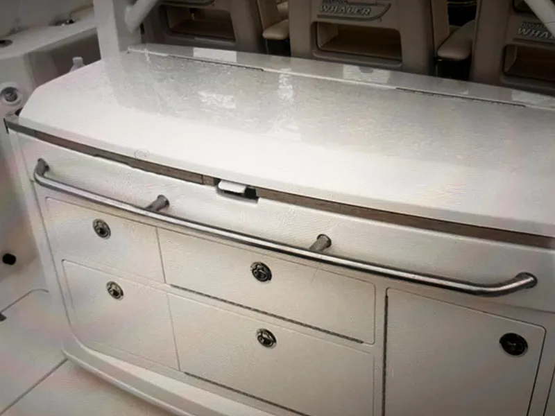 Slide: The Image of Boston Whaler 380 Outrage 2020 model boat storage and seating area. - 21