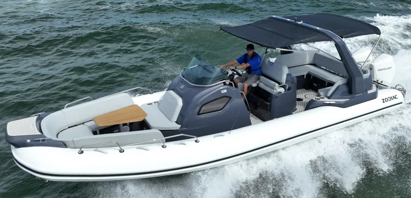 The Image of 2025 Zodiac Medline 9 boat cruising on water with canopy and seating area. - 0