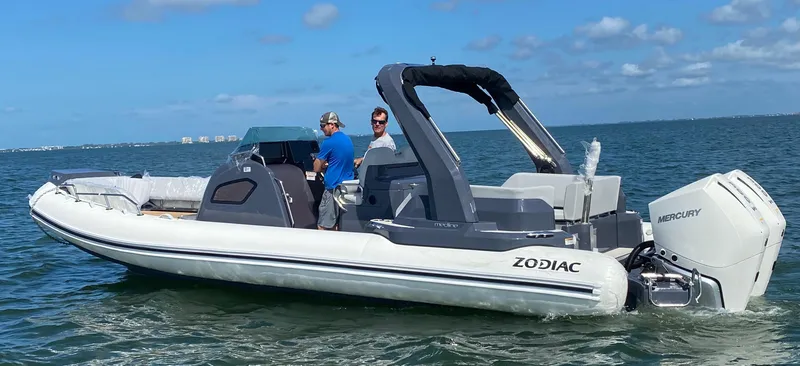 Slide: The Image of 2024 Zodiac Medline 9 boat cruising on the water with two people onboard. - 1