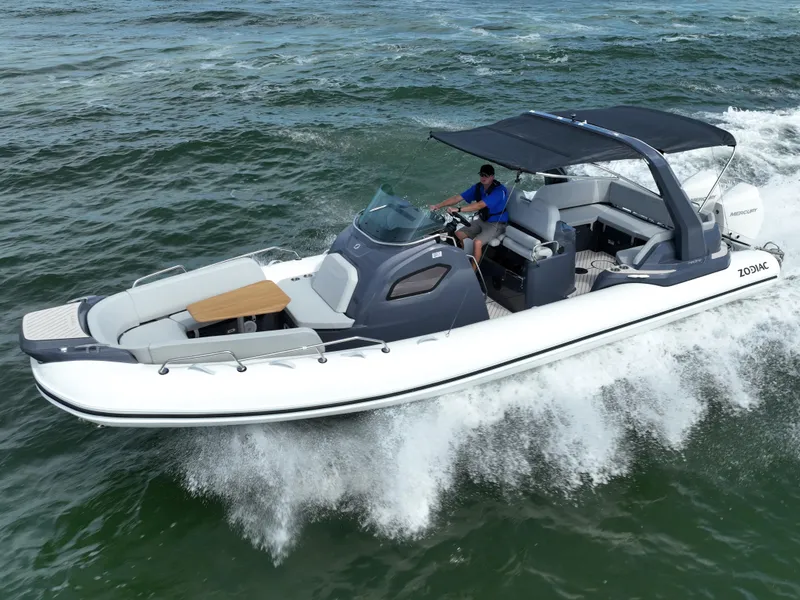 Slide: The Image of 2025 Zodiac Medline 9 boat cruising on open water with a canopy and seating area. - 6