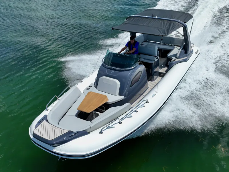 Slide: The Image of 2025 Zodiac Medline 9 boat cruising on clear green water. - 7