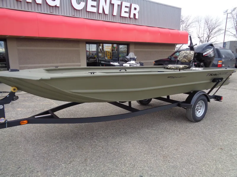 Slide: The Image of 2024 Tracker Grizzly 1654 T Sportsman boat on trailer outside dealership. - 2