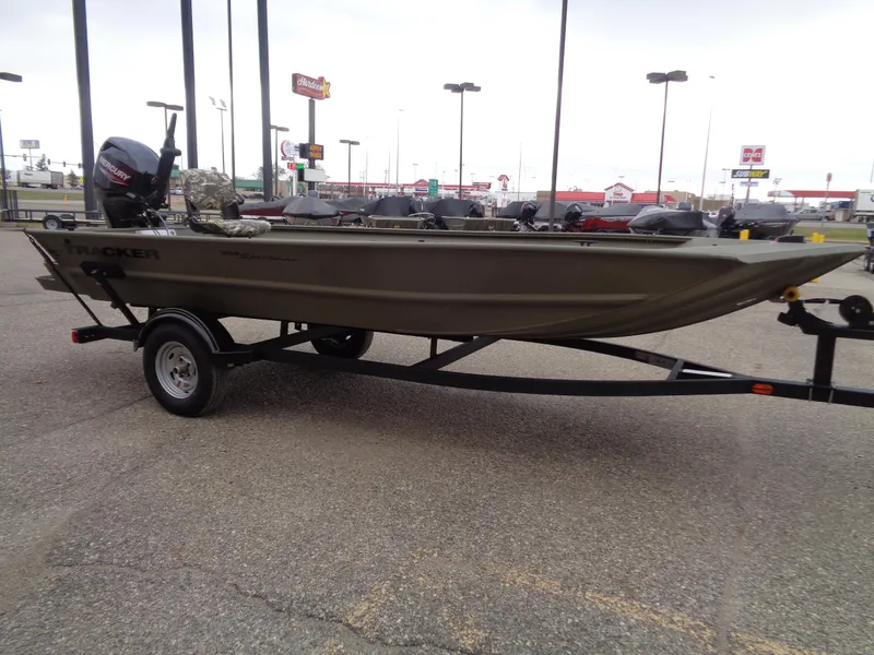 Slide: The Image of 2024 Tracker Grizzly 1654 T Sportsman boat on trailer in parking lot. - 3
