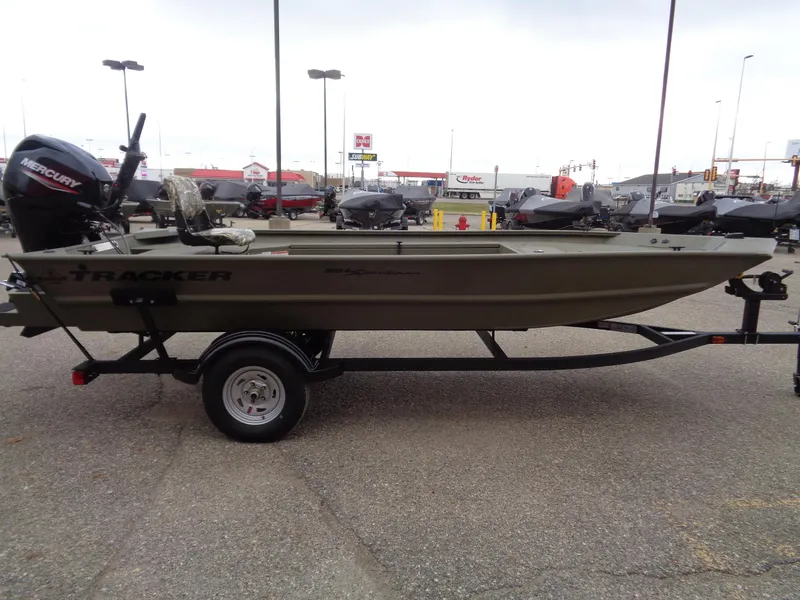 Slide: The Image of 2024 Tracker Grizzly 1654 T Sportsman boat on trailer in parking lot. - 4