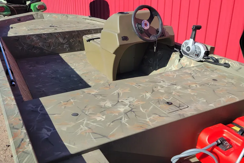 Slide: The Image of 2024 Tracker Grizzly 1648 SC boat with camouflage interior and steering console. - 5