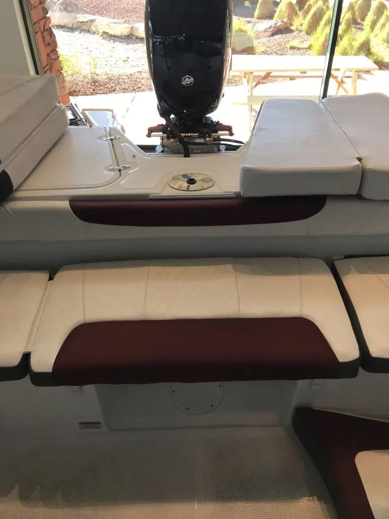 Slide: The Image of 2024 Tahoe 185 S boat interior with cushioned seating and motor. - 10