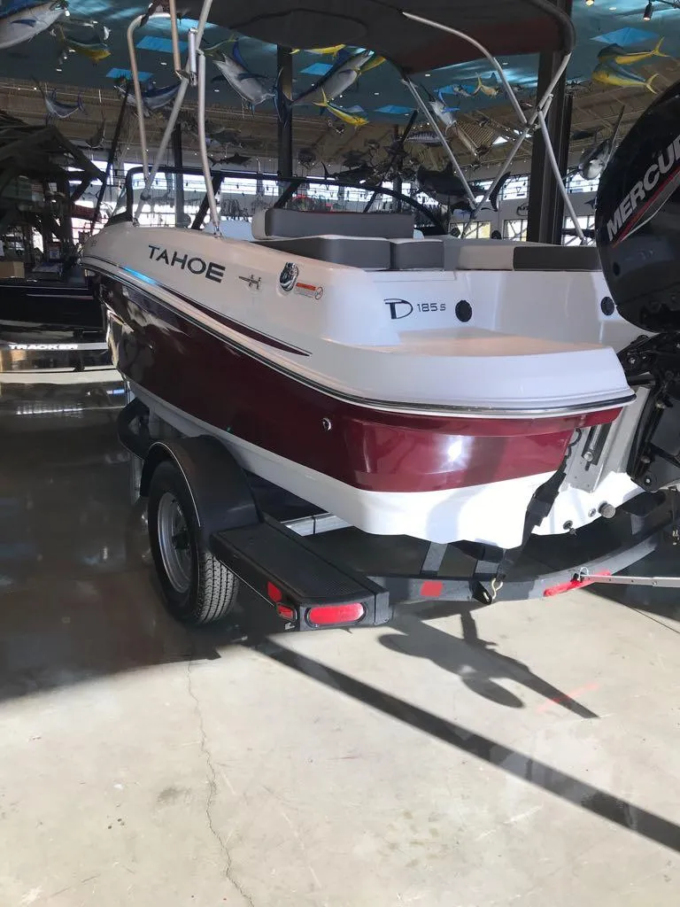 Slide: The Image of 2024 Tahoe 185 S boat on trailer in showroom. - 2
