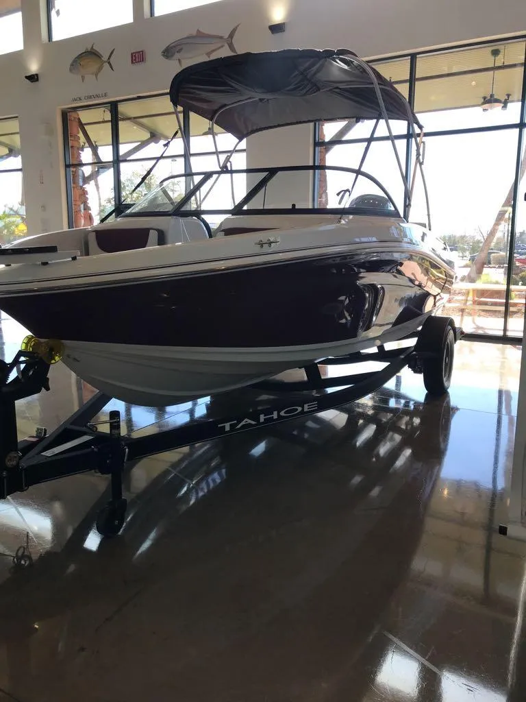 Slide: The Image of 2024 Tahoe 185 S boat displayed indoors on a trailer. - 39