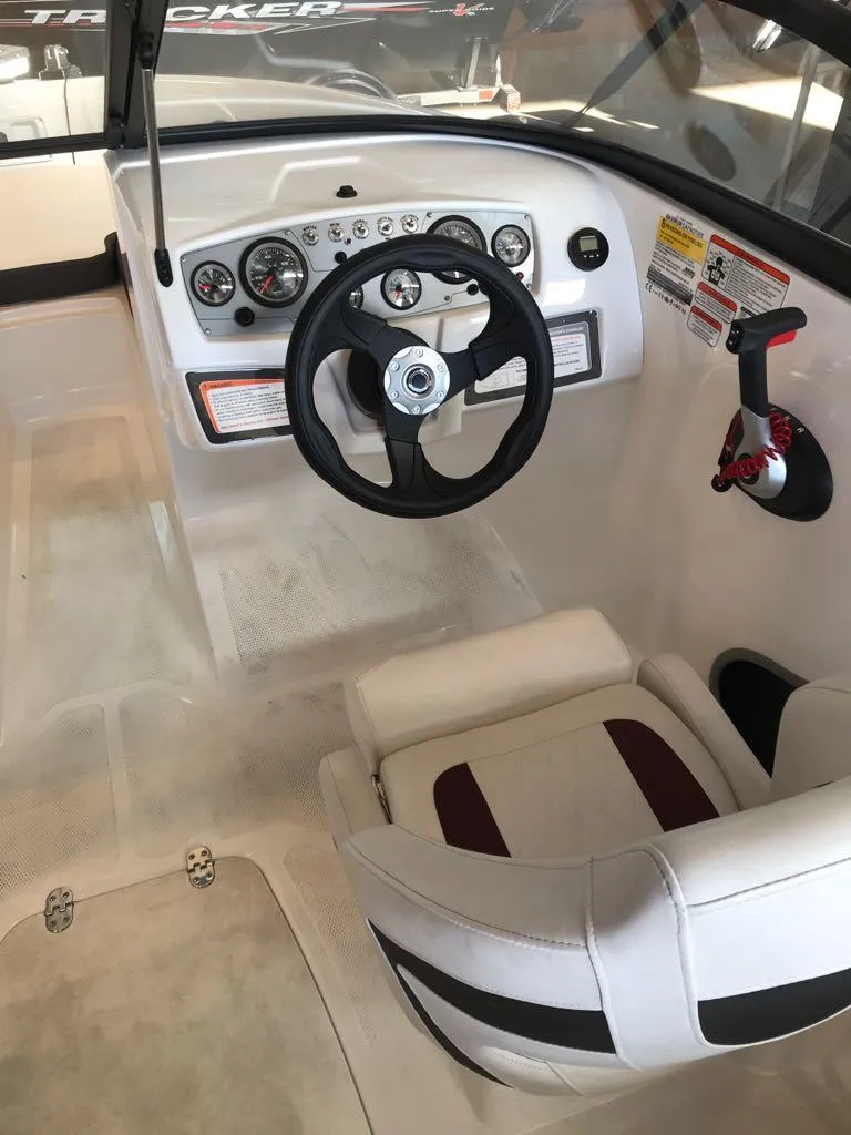 Slide: The Image of 2024 Tahoe 185 S boat interior with steering wheel and control panel. - 6