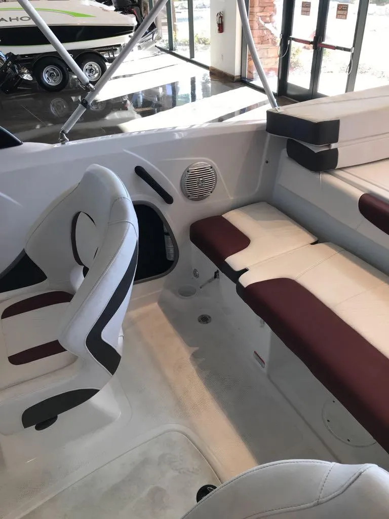 Slide: The Image of 2024 Tahoe 185 S boat interior with white and maroon seating. - 7