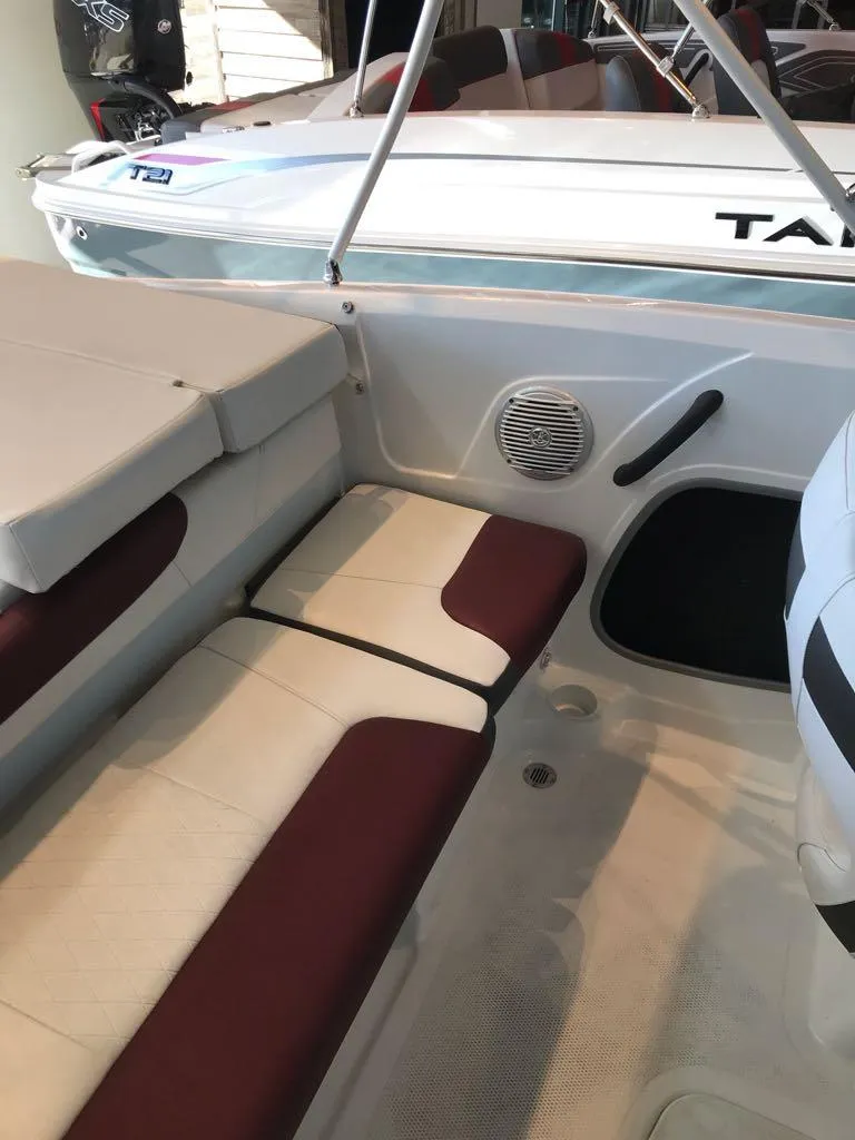 Slide: The Image of 2024 Tahoe 185 S boat interior with cushioned seating and speaker. - 9