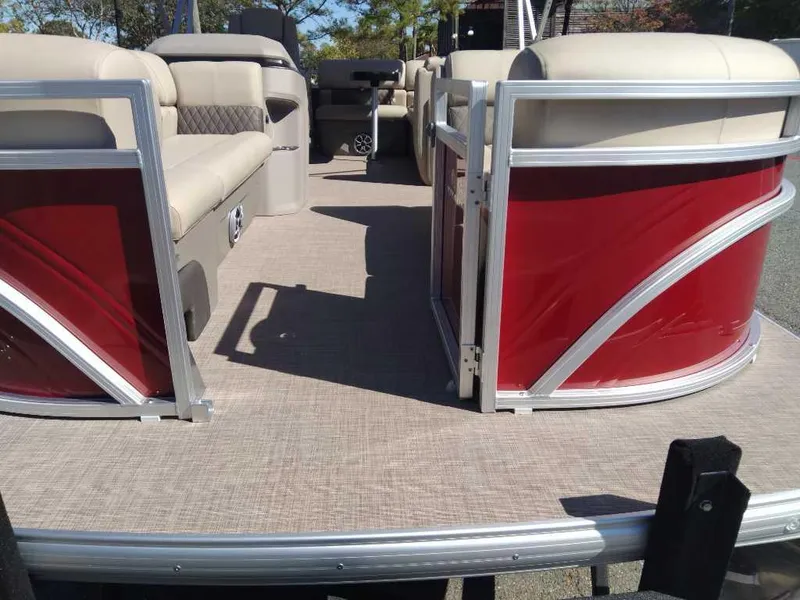 Slide: The Image of 2024 Sun Tracker Party Barge 20 DLX pontoon boat with beige seating and red paneling. - 10