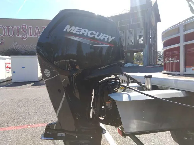 Slide: The Image of 2024 Sun Tracker Party Barge 20 DLX with Mercury outboard motor in parking lot. - 7