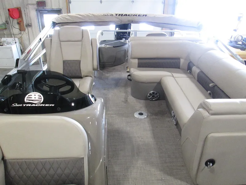 Slide: The Image of 2023 Sun Tracker SPORT FISH 22 XP3 pontoon boat interior with beige seating. - 22