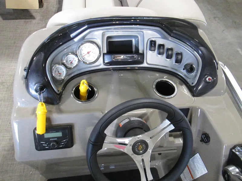 Slide: The Image of 2023 Sun Tracker SPORT FISH 22 XP3 boat dashboard with steering wheel and gauges. - 23