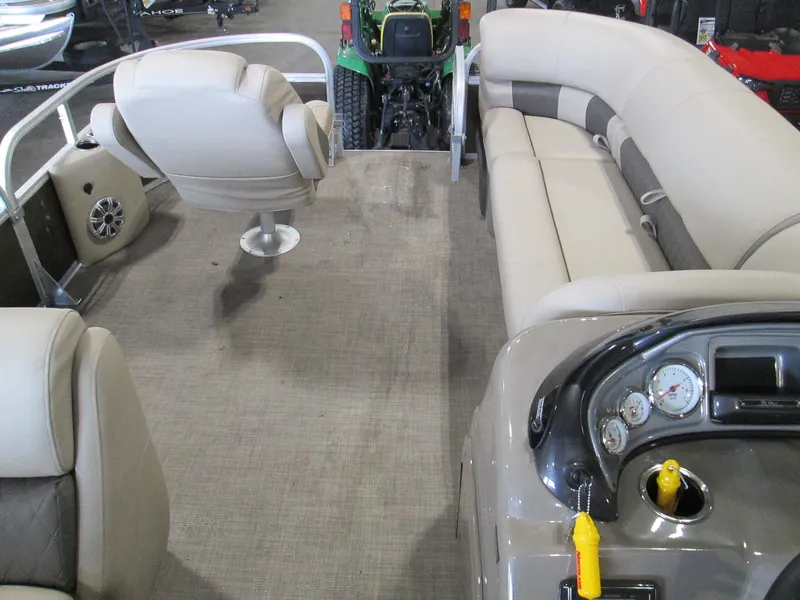 Slide: The Image of 2023 Sun Tracker SPORT FISH 22 XP3 pontoon boat interior with beige seating and control panel. - 26