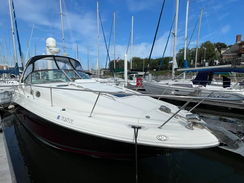 Slide: The Image of 2006 Sea Ray 320 Sundancer docked at a marina with sailboats. - 10