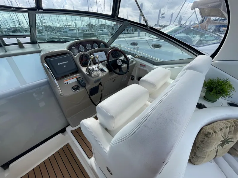 Slide: The Image of Cockpit of a 2006 Sea Ray 320 Sundancer with steering wheel and navigation equipment. - 15