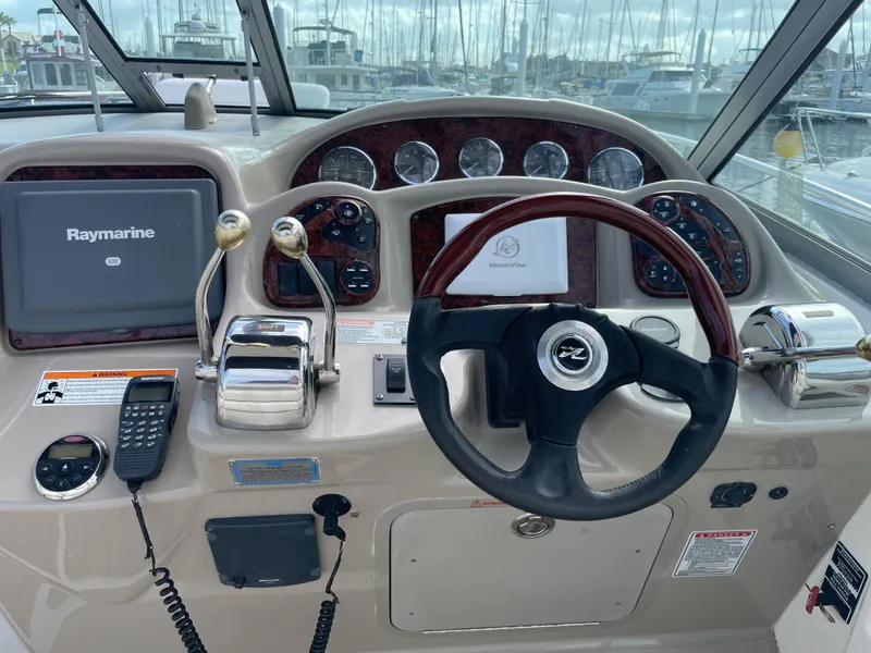Slide: The Image of 2006 Sea Ray 320 Sundancer helm with Raymarine navigation system. - 17