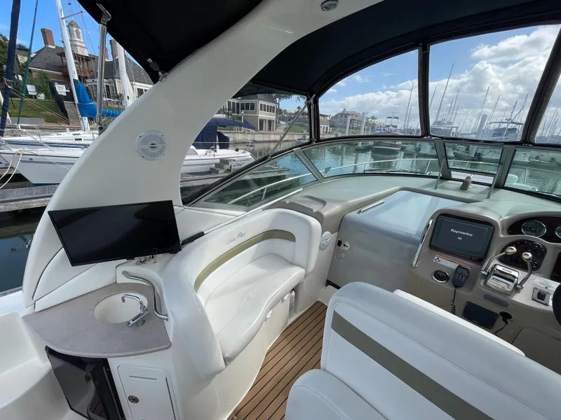 Slide: The Image of Interior of 2006 Sea Ray 320 Sundancer yacht with helm and seating area. - 19