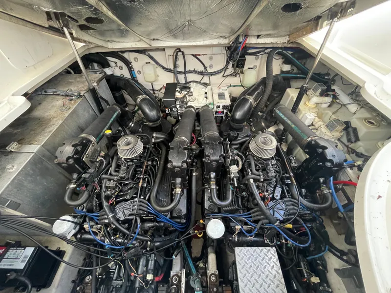 Slide: The Image of 2006 Sea Ray 320 Sundancer engine compartment with twin engines and wiring. - 23