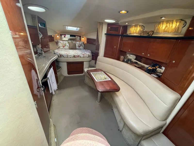 Slide: The Image of Luxurious interior of 2006 Sea Ray 320 Sundancer with cozy seating and elegant wood finishes. - 24