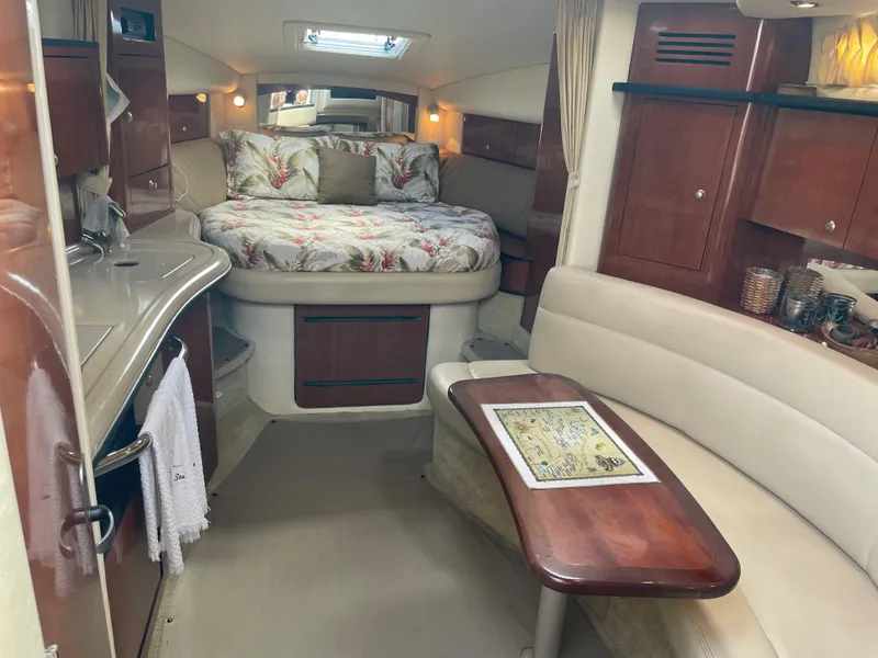 Slide: The Image of Interior of 2006 Sea Ray 320 Sundancer with bed, kitchenette, and seating area. - 26