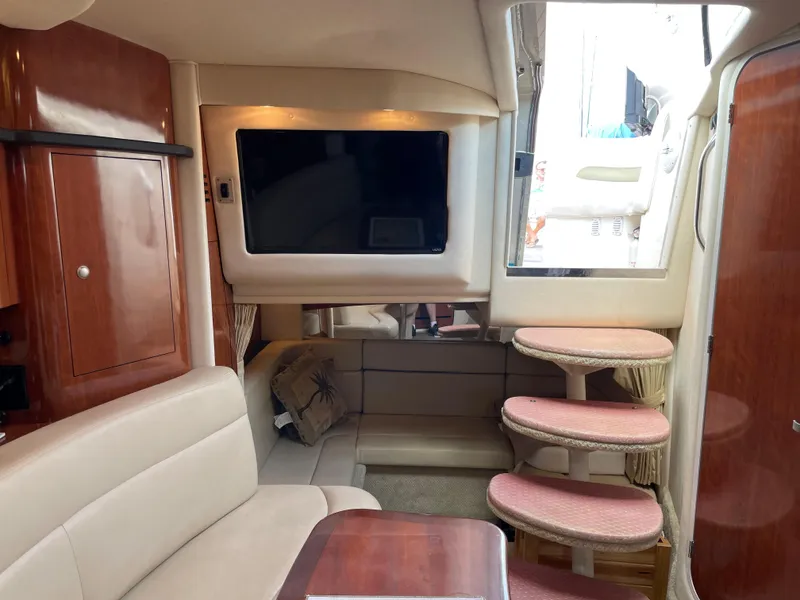 Slide: The Image of 2006 Sea Ray 320 Sundancer interior with TV, seating, and stairs. - 31