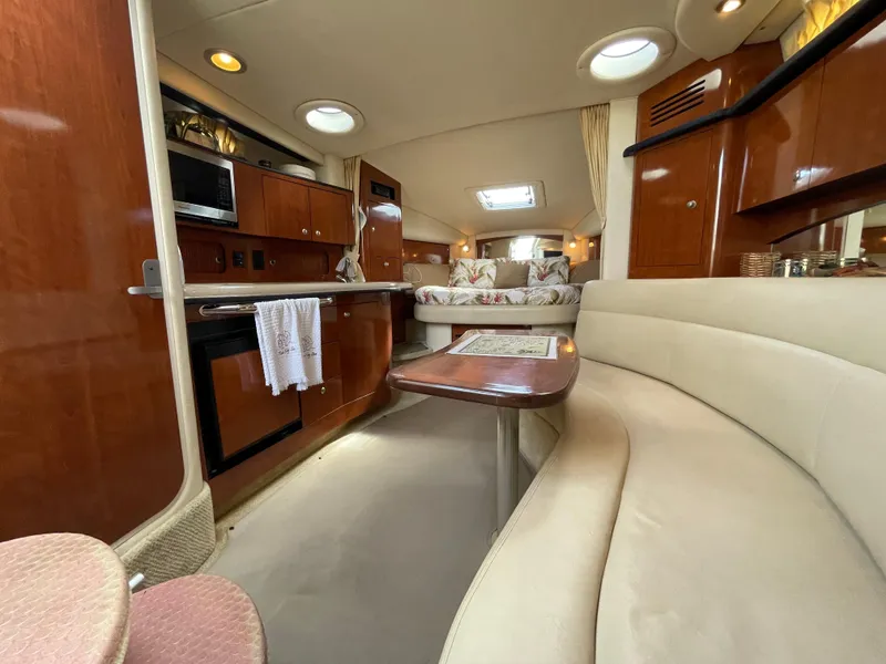 Slide: The Image of Interior of 2006 Sea Ray 320 Sundancer with kitchen, dining area, and cozy seating. - 34