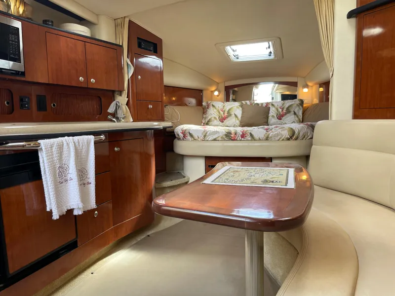 Slide: The Image of Interior of 2006 Sea Ray 320 Sundancer with cozy seating, kitchenette, and bed. - 35