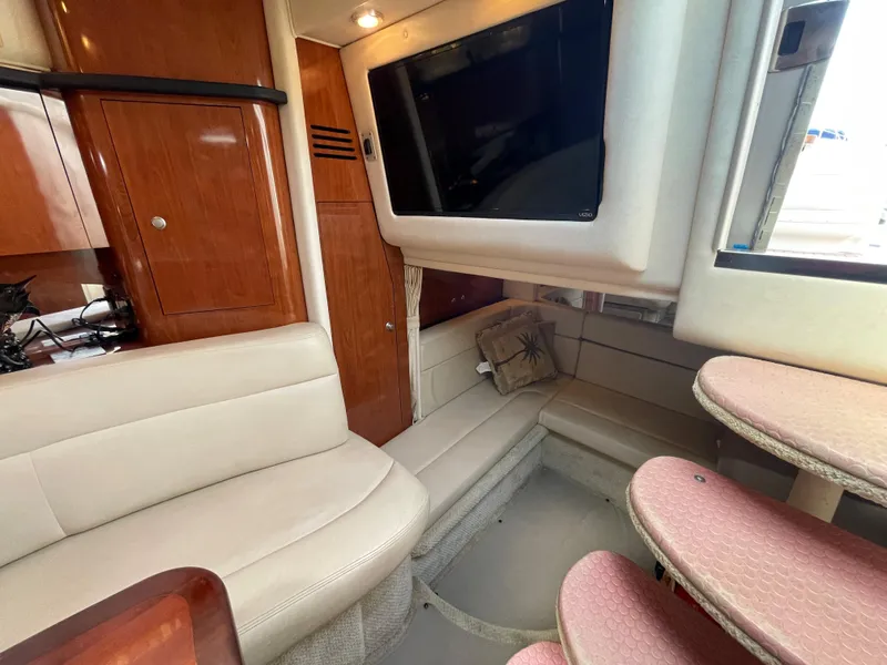 Slide: The Image of Interior of 2006 Sea Ray 320 Sundancer with TV, seating, and wooden cabinetry. - 37